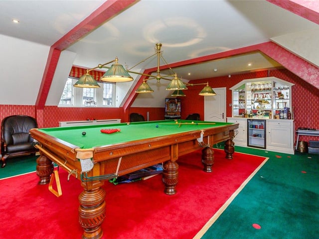 The large games room is accessed via a spiral staircase and houses a full size snooker table, bar area and bespoke handmade carpet.