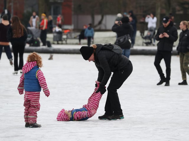 People on a shallow frozen pond in Queen's Park in Glasgow. Picture: Andrew Milligan/PA Wire