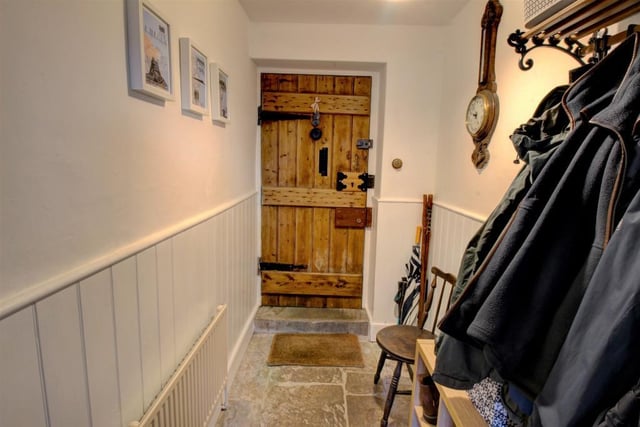 Entry via the front door into a spacious internal porch that retains the original stone flag flooring. This is complemented beautifully by the half height wood panelling on the walls.