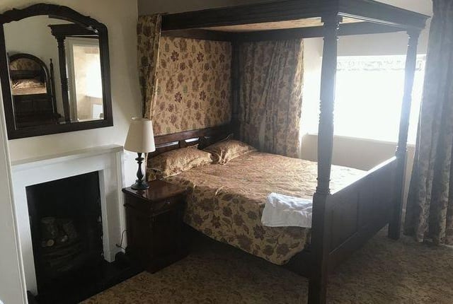 This bedroom has a real four poster bed and couldn't look quainter if it tried,