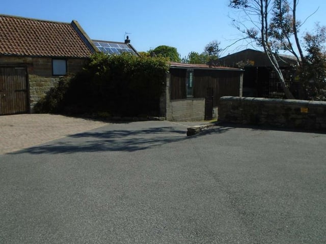 There are several outbuildings, plus space to park more than 10 vehicles.