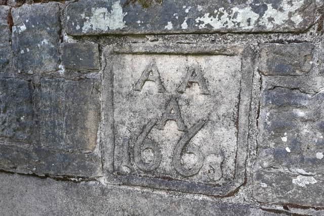 A date stone from the original hall, with three ‘A’s of the couple who had the hall built, Alexander and Alice Ashton, and the date: 1663.