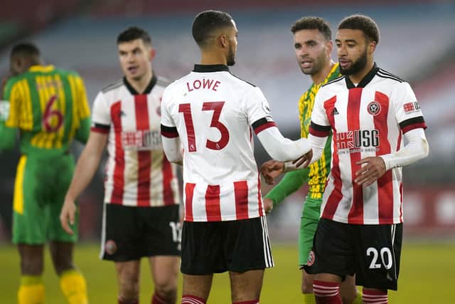 Sheffield United's Max Lowe greets Jayden Bogle after the final whistle during the Premier League match at Bramall Lane, Sheffield: Tim Keeton/PA Wire.