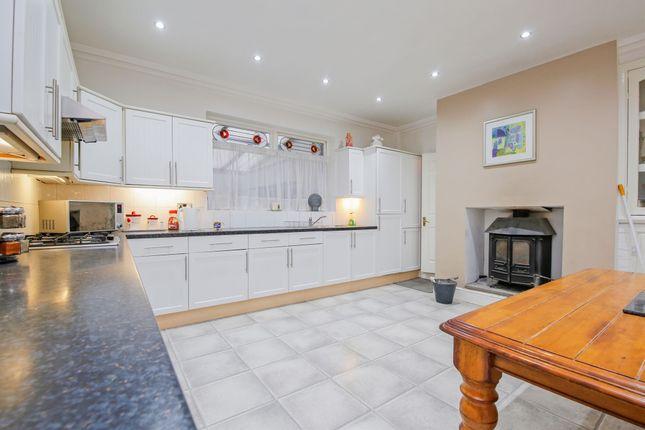 The property includes many characteristics of a period home, including a feature open fireplace in the kitchen.