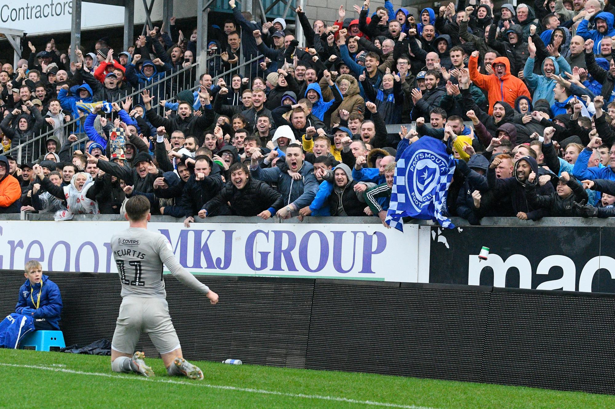 Ronan Curtis celebrates in front of the travelling Fratton faithful following his goal against Bristol Rovers in October.