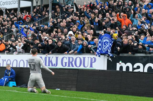 Ronan Curtis celebrates in front of the travelling Fratton faithful following his goal against Bristol Rovers in October.