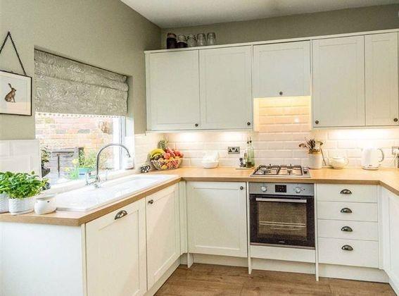The kitchen has integrated appliances including a fridge freezer, oven and hob, dishwasher and washer/dryer, alongside attractive worktops.