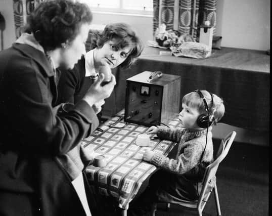 A pupil and teachers at Donaldson's School for the Deaf in February 1963.