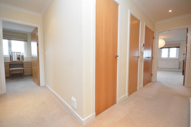 Hall with storage cupboards.