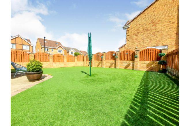 Purplebricks describes the back garden as child friendly. At the front of the house is a driveway providing parking for several vehicles .
