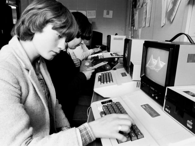 Secondary school pupils work with the latest Apple II computers at the Wester Hailes Education Centre (WHEC) in Edinburgh, October 1980.