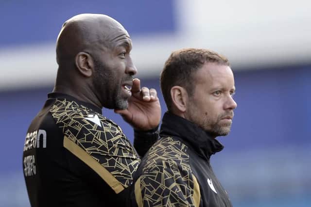 Sheffield Wednesday boss Darren Moore and his assistant Jamie Smith watch on.