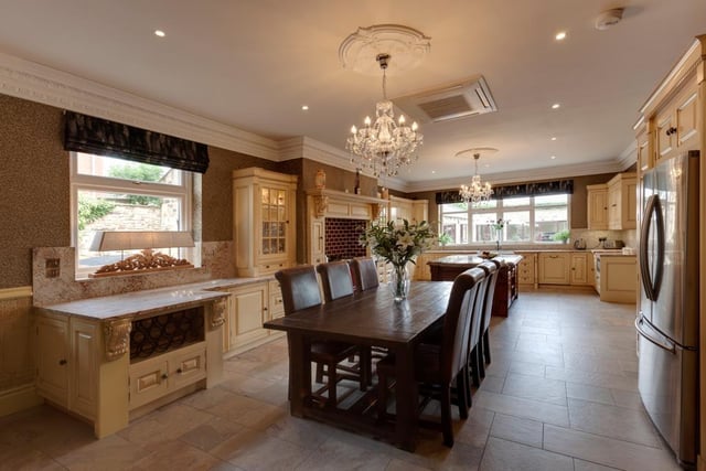 The dining kitchen is fitted with an Aga range cooker and features a central island with beautiful granite countertops.