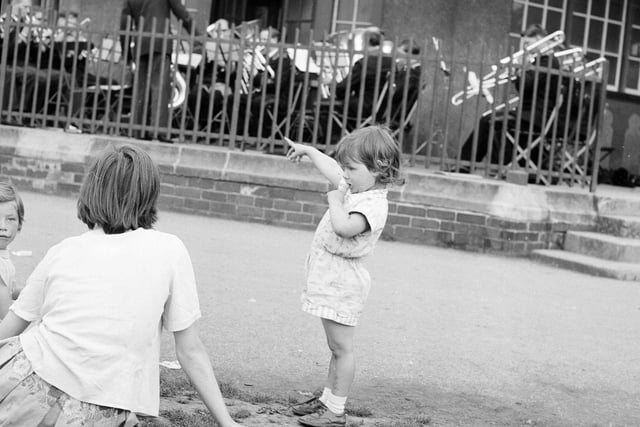 Children listen to bandsmen in Inverleith Park in August 1963.