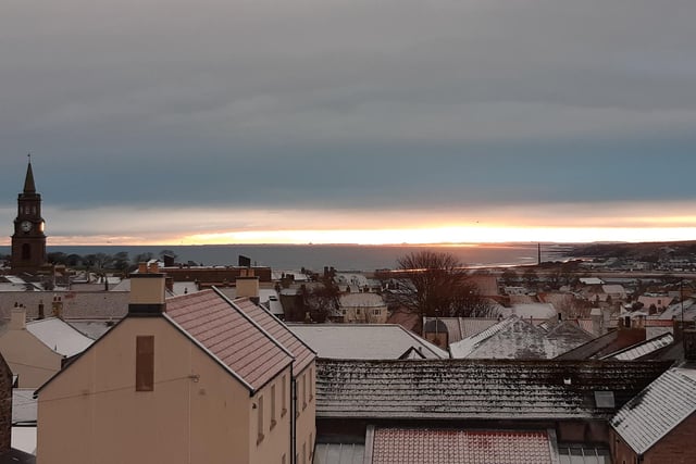 Sunrise over Berwick with Lindisfarne Castle and Bamburgh Castle on the horizon.