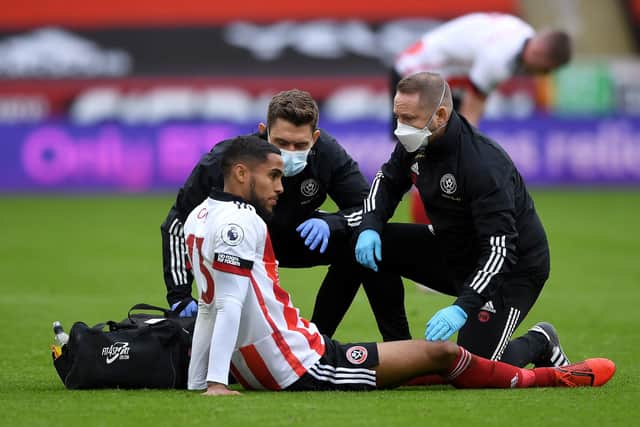 Sheffield United's Max Lowe receives treatment following his collision with Rubden Loftus Cheek and is set to miss the trip to Liverpool: Gareth Copley/PA Wire.