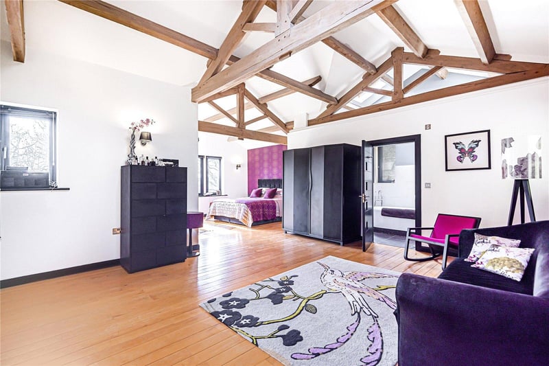 There are four bedrooms in total, including this large master suite with a beautiful vaulted ceiling and access to a balcony which overlooks the rear garden, as well as a generous sitting area and dressing room.