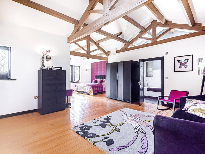 There are four bedrooms in total, including this large master suite with a beautiful vaulted ceiling and access to a balcony which overlooks the rear garden, as well as a generous sitting area and dressing room.