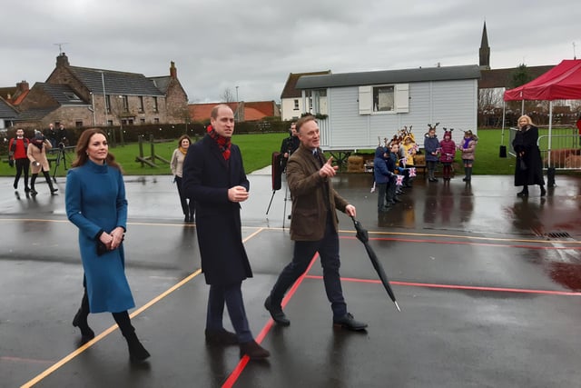 The Duke and Duchess are shown around the school from the playground.