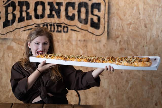 Sabrina Flower, 20 of Sheffield takes on one of the UkKs largest hotdogs, measuring in at 3 feet! (photo by Tom Maddick / SWNS)