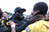 George Elokobi, manager of Maidstone United, embraces with Liam Sole after the FA Cup win over Stevenage.