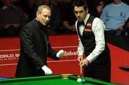 Pictured is Sheffield snooker referee Brendan Moore, left, with Ronnie O'Sullivan.