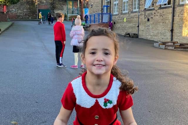 A pupil gets into the spirit of the Santa Dash at Westways Primary School, Crookes, which has raised over £2,000 for Sheffield Children's Hospital from Christmas events