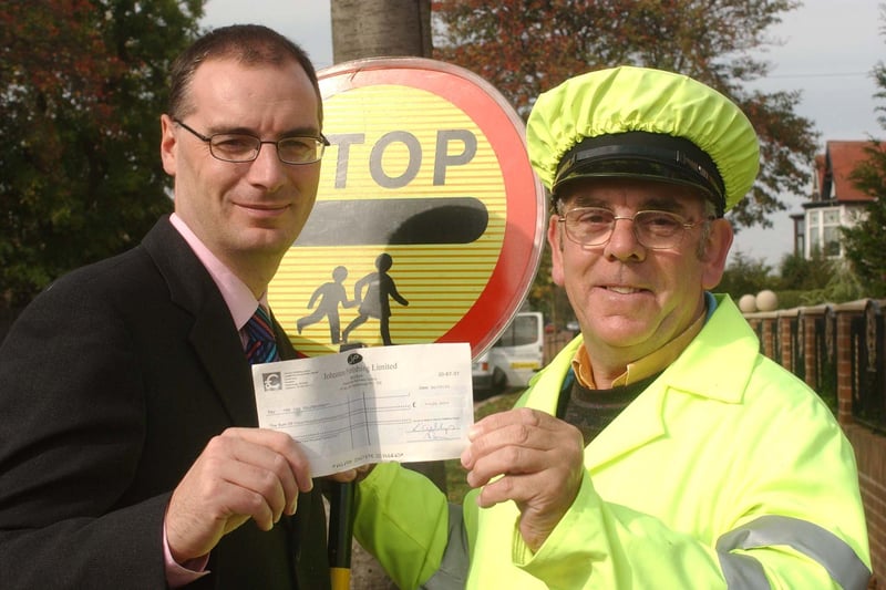 Lollipop man Ian Palfreyman was lollipop man of the year in 2003 and here he is receiving his cheque from Rob Lawson from the Sunderland Echo.