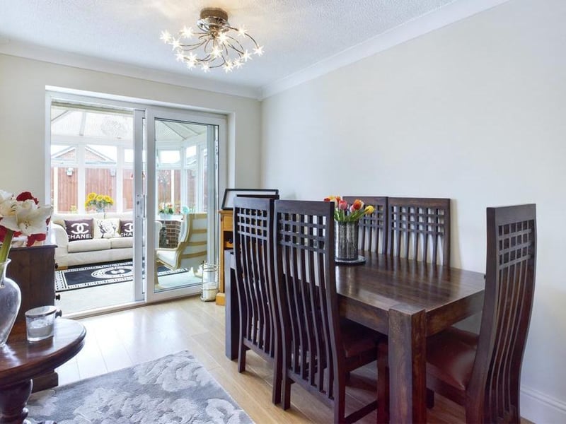 Dining Room - uPVC double glazed sliding patio door opening into the conservatory, ceiling coving, wood effect laminate flooring, radiator panel and power points.