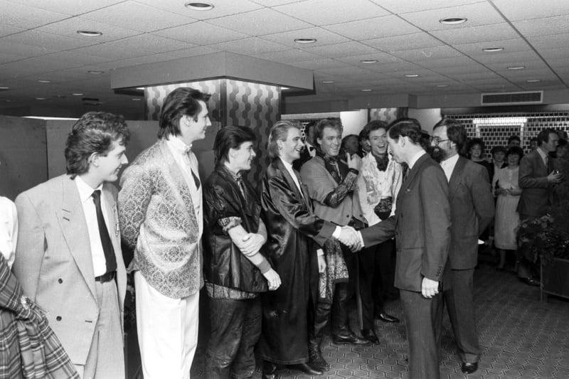 Spandau Ballet's Steve Norman and the Kemp brothers share a joke with Prince Charles after their concert at Ingliston in Edinburgh, November 1984. 