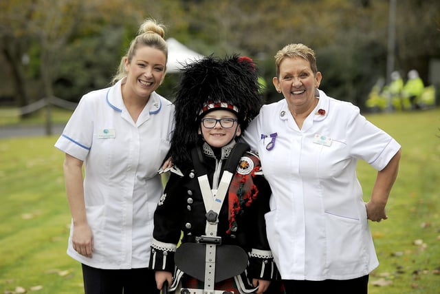 An Alloa Bowmar Pipe Band member takes a break with Strathcarron Hospice staff during Princess Anne's 2017 visit