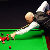 CHELTENHAM, ENGLAND - JANUARY 18: Joe Perry of England plays a shot in his first round match against Luca Brecel of Belgium in the 2023 World Grand Prix at Centaur Arena on January 18, 2023 in Cheltenham, England. (Photo by Dan Istitene/Getty Images)
