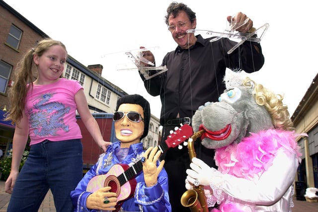 Puppeteer Jim Weeks shows markets visitor Bobbie-Jo Betts, aged 10, who's visiting her grandma in Rotherham, puppets Elvis and Henrietta Hot Lipps.