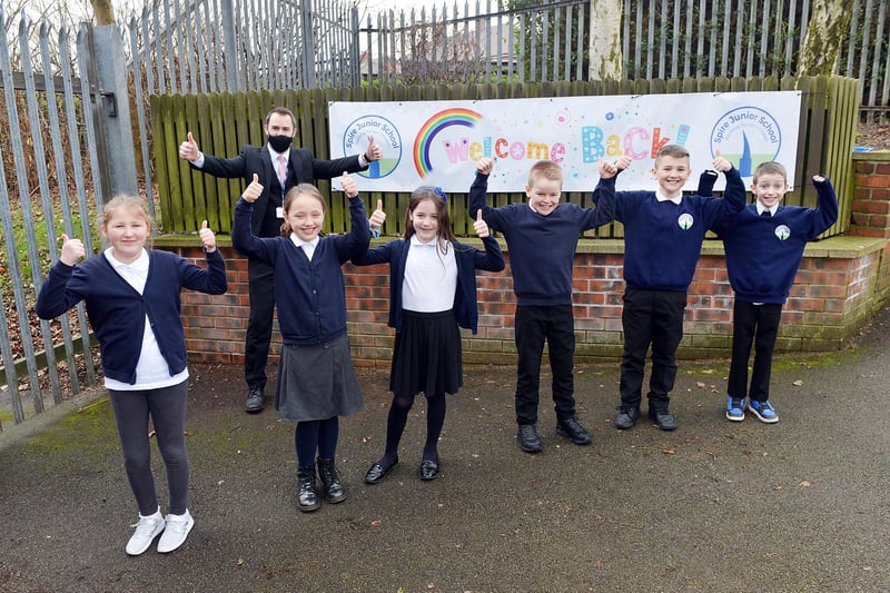 Children at Spire Junior School give a thumbs up to the return to school