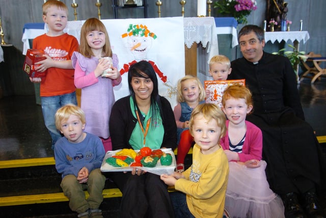 Children at Little Learners Day Nursery enjoyed a Harvest Festival at the Doncaster Deaf Trust's Holy Trinity chapel in 2011. Back L-R are Joshua Fisher, three, Hannah Bond, four, Alice McIlwraith, Alexander Thornley, both three, and Father Jeffrey Stokoe. Front L-R are Jake Bailey, three, nursery nurse Sabrina Aftab, Isaac Dunn, four, and Amber Bailey, three.