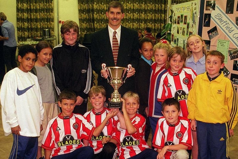 Pupils from Arbourthorne Junior School receive the Dave Aizlewood memorial trophy from Ian Spooner the chairman of Sheffield Schools Athletics Association, for them gaining the most points at the city championships, October 1999