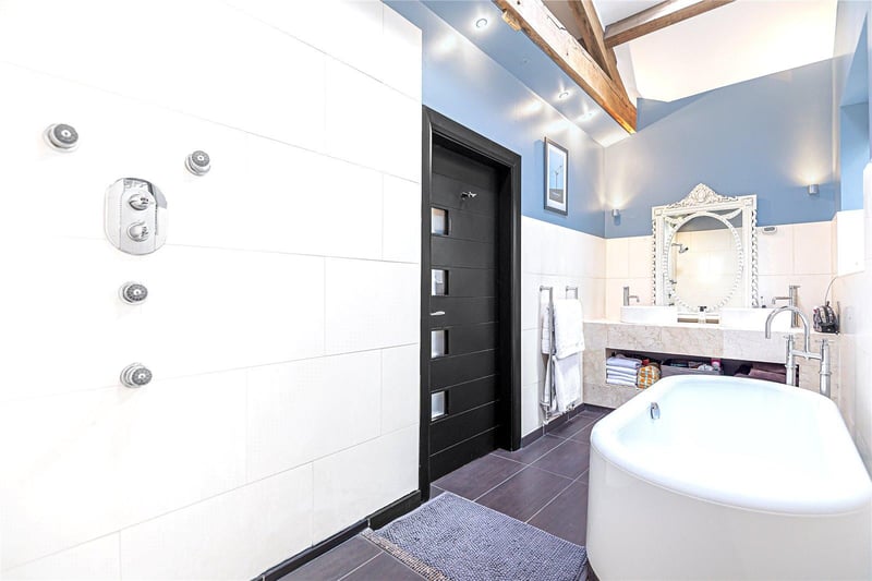 All four bedrooms in the property benefit from their own en-suite facilities, with the master enjoying this modern suite with dual sinks, bathtub and shower.
