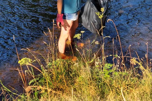 Jane Turnbull collecting rubbish from the River Derwent.