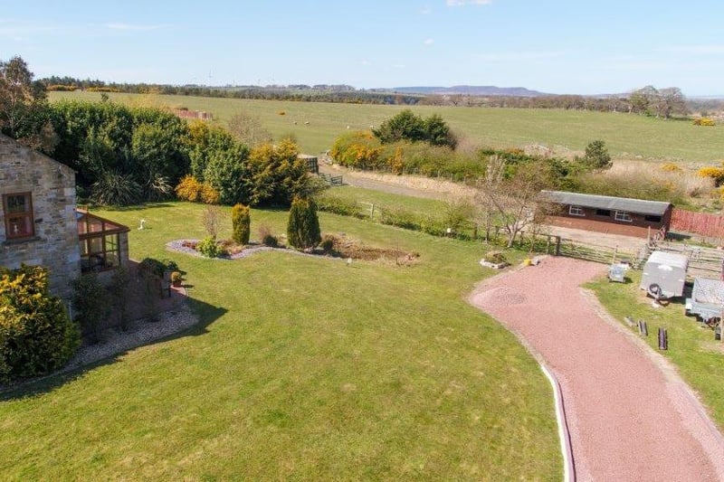 An aerial view of the garden towards the stables.