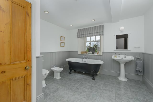 The family bathroom includes a free standing roll top bath and a further separate shower room.