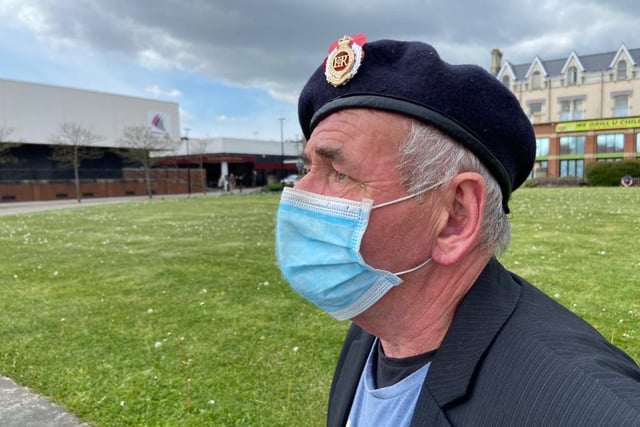Veteran Joseph Copeland wears a face mask as he pays his respects at Hartlepool's war memorial.