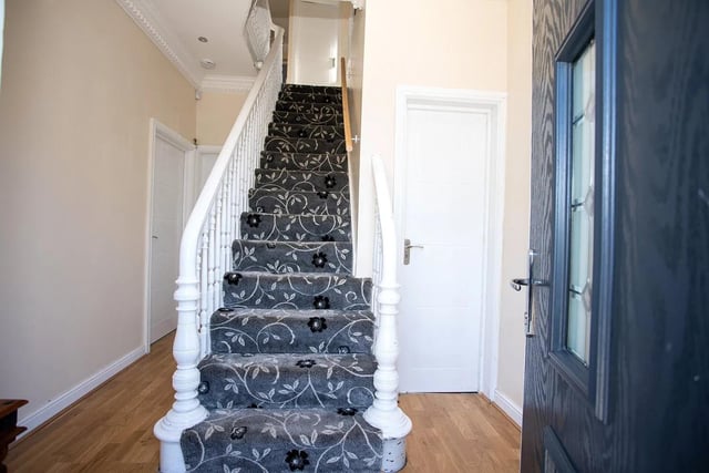 A commanding staircase leads to the first floor.
