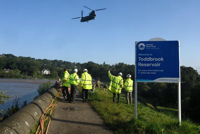 A Chinook helicopter leaving the area after dropping sandbags onto the dam wall at Toddbrook reservoir following a severe structural failure after heavy rain