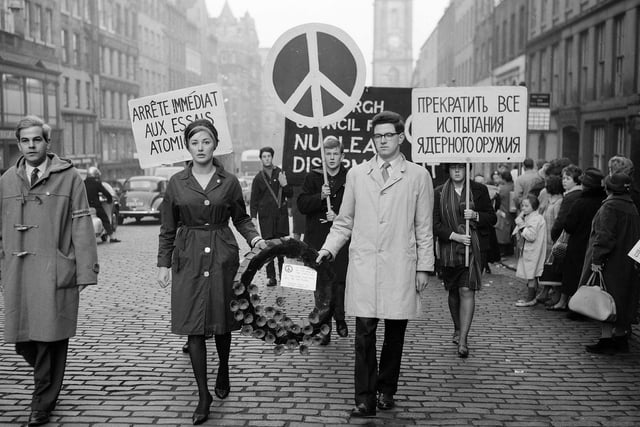 Ban the Bomb marchers are pictured on the High Street, led by Mr D'Arcy and Miss Ann Hutchison, as part of Edinburgh Council for Nuclear Disarmament (CND) in November 1961.