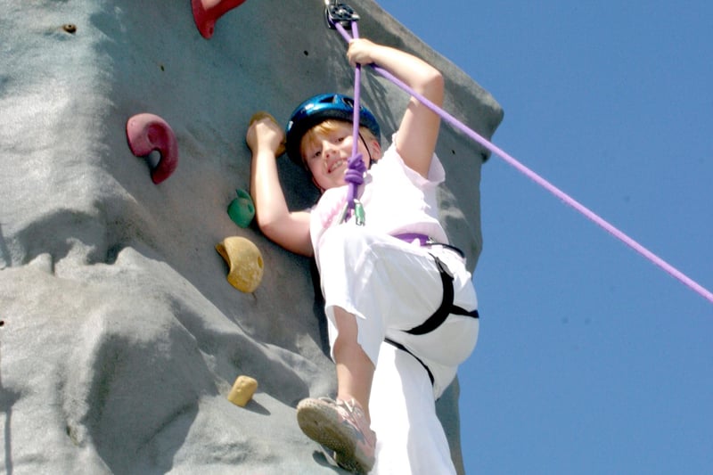 Smiling for the camera on the climbing wall