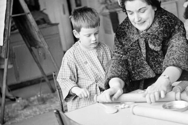 Teaching a child at Granton Nursery how to roll dough in 1964.