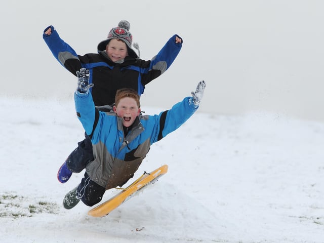 Ben Barron (seven), top and his brother James (eleven), from Purbrook enjoy the snow on Portsdown Hill.