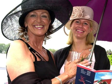 Ladies sheltering from the rain at the Doncaster race course in 2003.