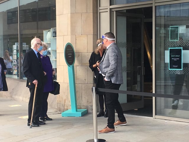One couple visiting the store dressed smartly for the occasion as they waited to get in arm in arm
