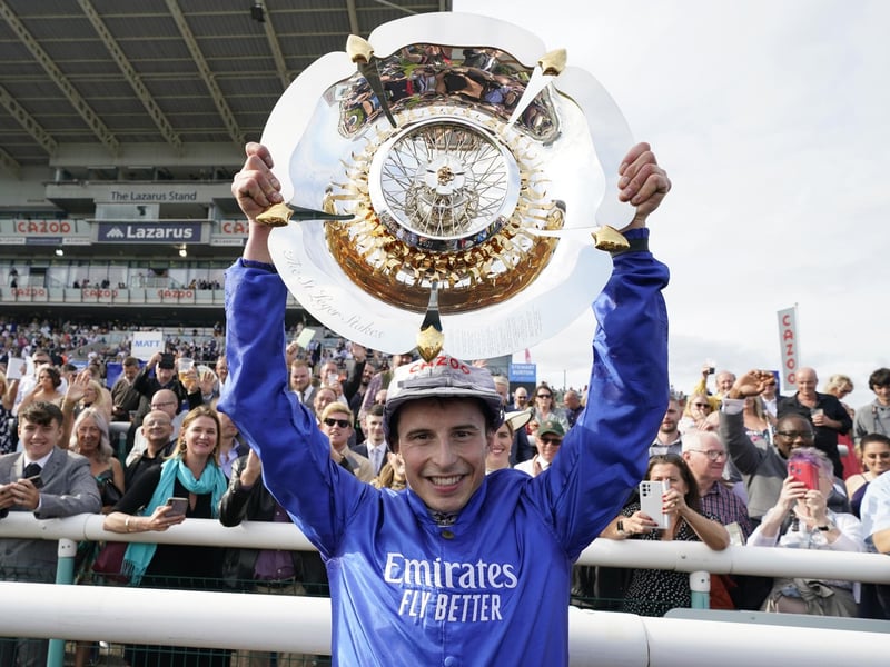 William Buick celebrates with the trophy after riding Hurricane Lane to win in 2021. 
